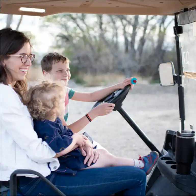 Mom and kids driving golf cart