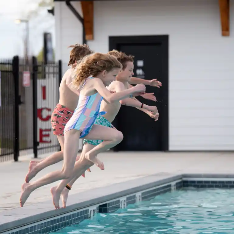 Kids jumping into the swimming pool
